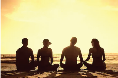 Four people sitting cross-legged